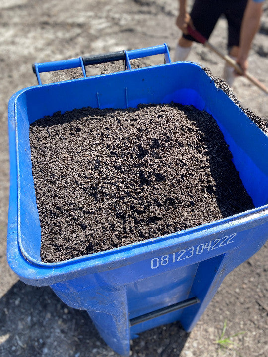 Blue toter filled with compost